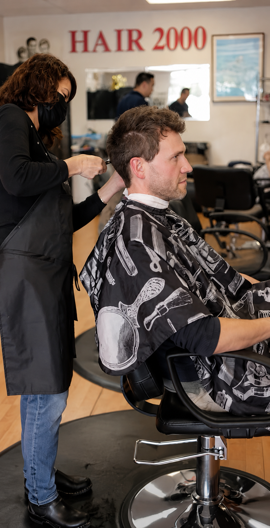 Stylist giving a precision haircut at Hair 2000 Marin County
